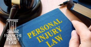 This photo depicts a personal injury definition book being held by a lawyer. The car accident lawyers from Franchi Law can explain personal injury law definitions to Tampa auto accident victims.