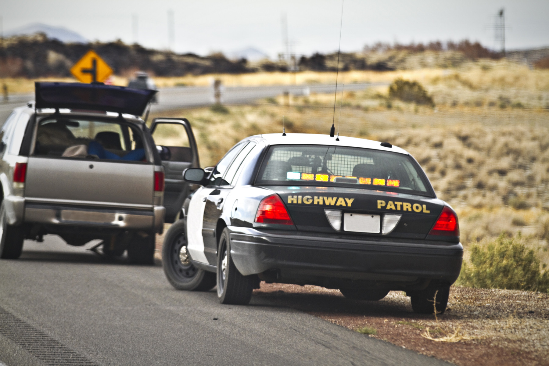 police car stopping other car on side of the road